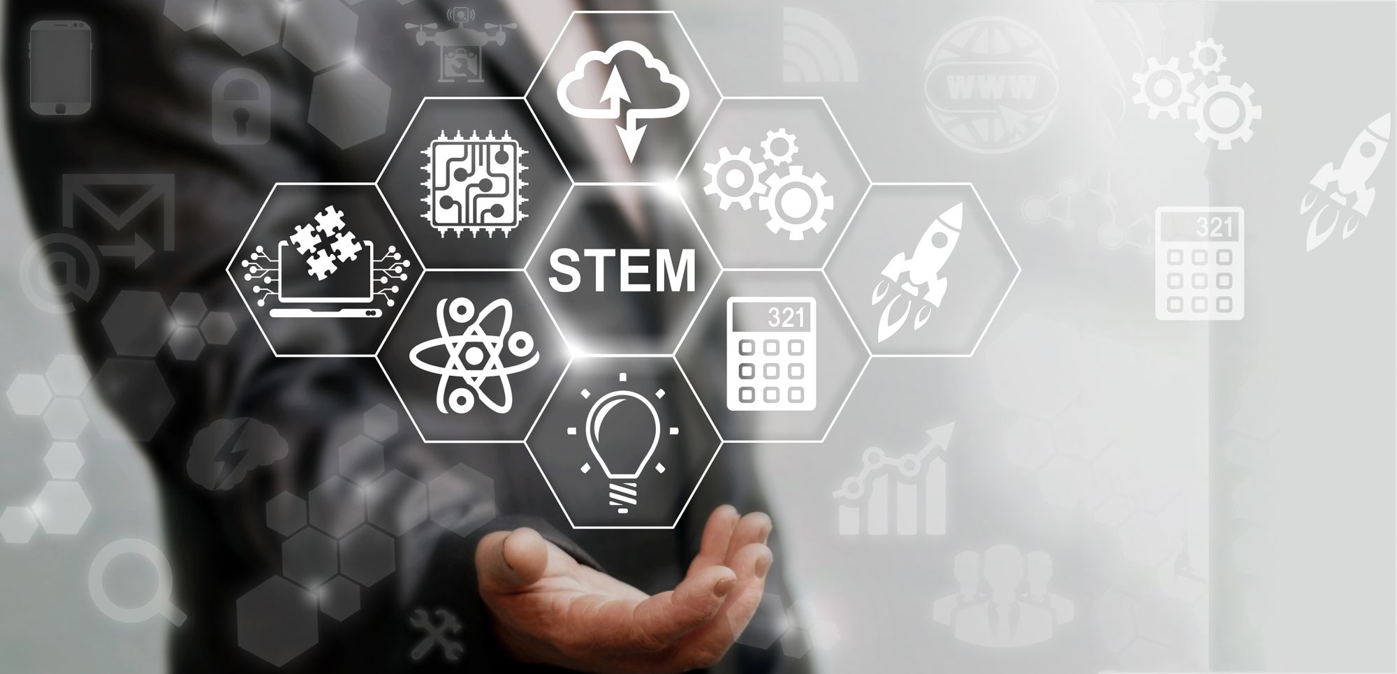 stylized image of hand holding graphic of STEM sciences
