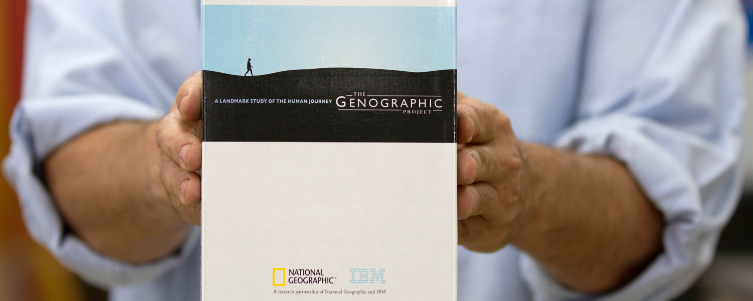 Matt Kaplan is holding a National Geographic box of the human journey the Genographic project
