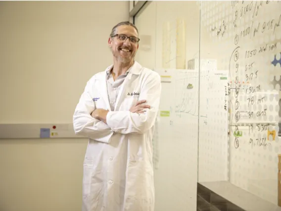 Ryan Sprissler stands against a wall in his lab