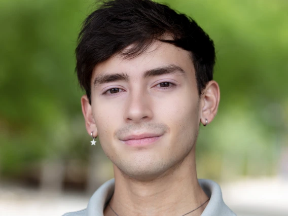 Dark haired young man with light blue shirt