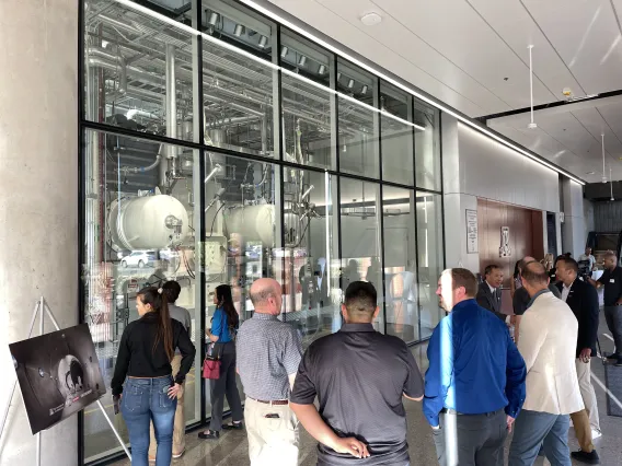 Attendees admire the Thermal Vacuum Chamber after its unveiling in the Applied Research Building.