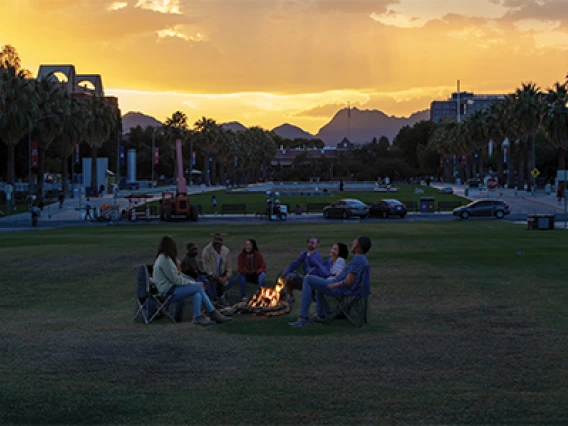 Image of group around campfire is AI generated.  