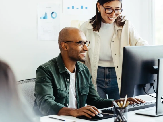 Stock image of people working around a computer