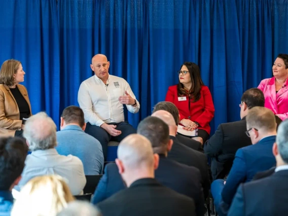 four people on stage holding a panel discussion