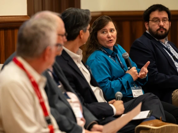 Dawn Wellman speaking to other people sitting on a panel presentation
