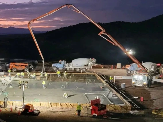 cement trucks at a construction site pouring cement