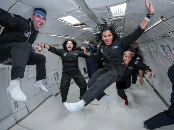 seven people floating in microgravity flight in Zero G