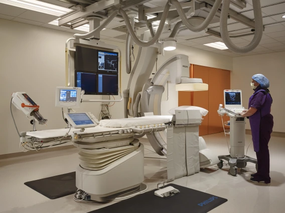 Cancer centeer equipment operated by a woman in purple scrubs