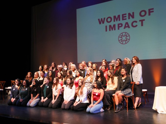 The 2023 Women of Impact and Young Women of Impact cohorts pose for a picture after the awards celebration.