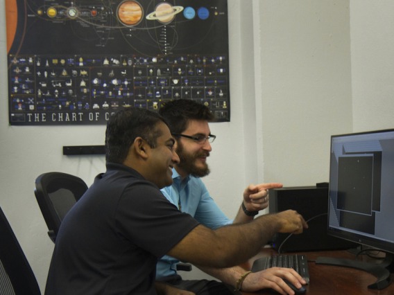 Reddy and Campbell examine their animation of a Chinese space station flyby. 
