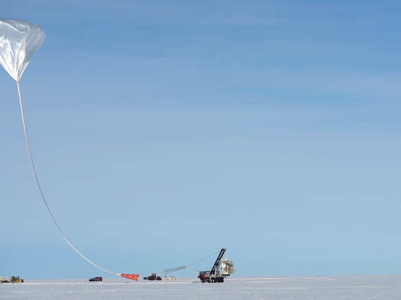 Tethered by a long cable, the high altitude balloon carrying the GUSTO telescope is being launched from McMurdo Research Station in Antarctica.