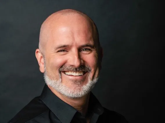 Doug Hockstad wearing a black shirt and smiling