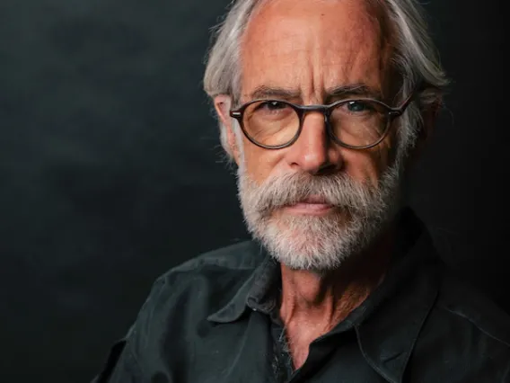 Portrait of Joaquin Ruiz wearing glasses and a black button down shirt