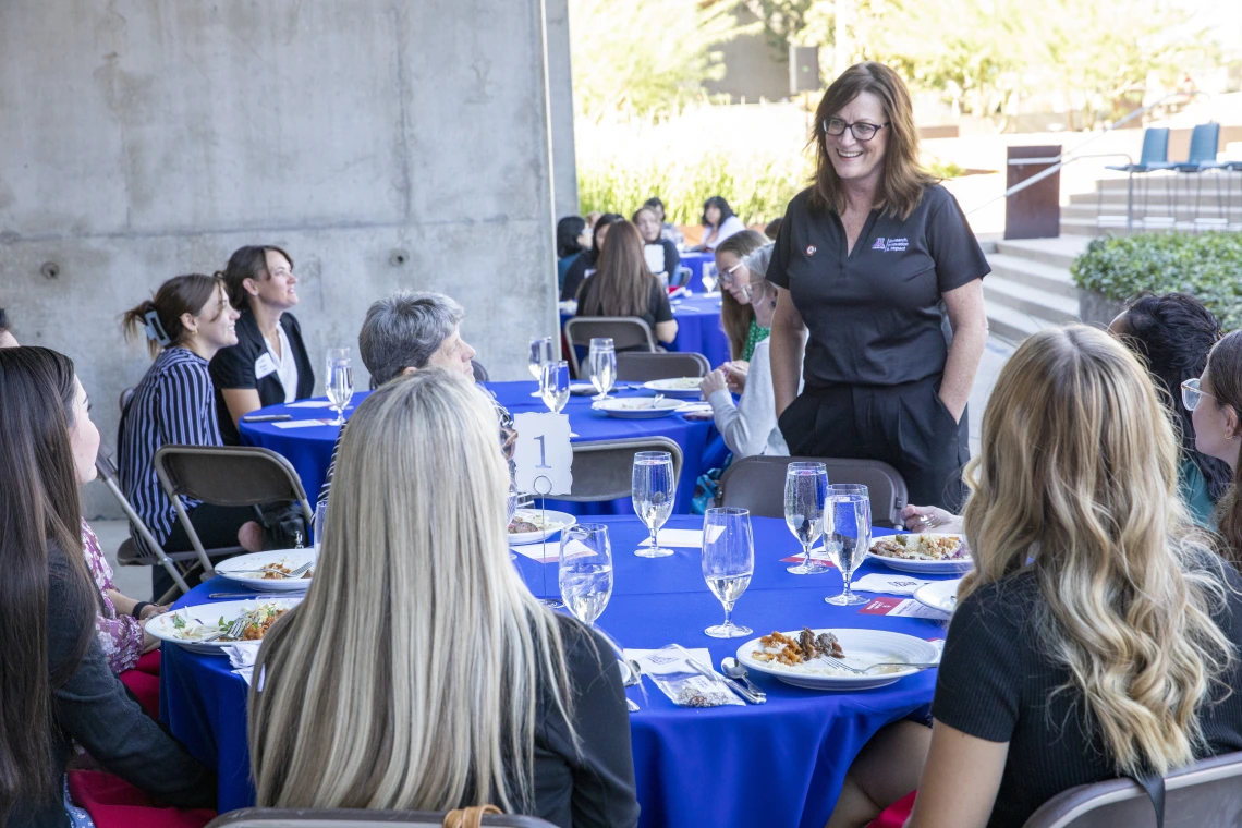 Image of Lisa Romero speaking with YWOI/WOI honorees