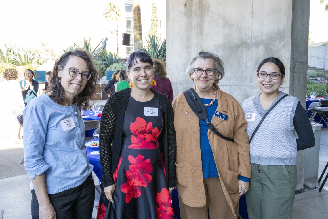 A group of four women gather for the 2024 Young Women of Impact luncheon