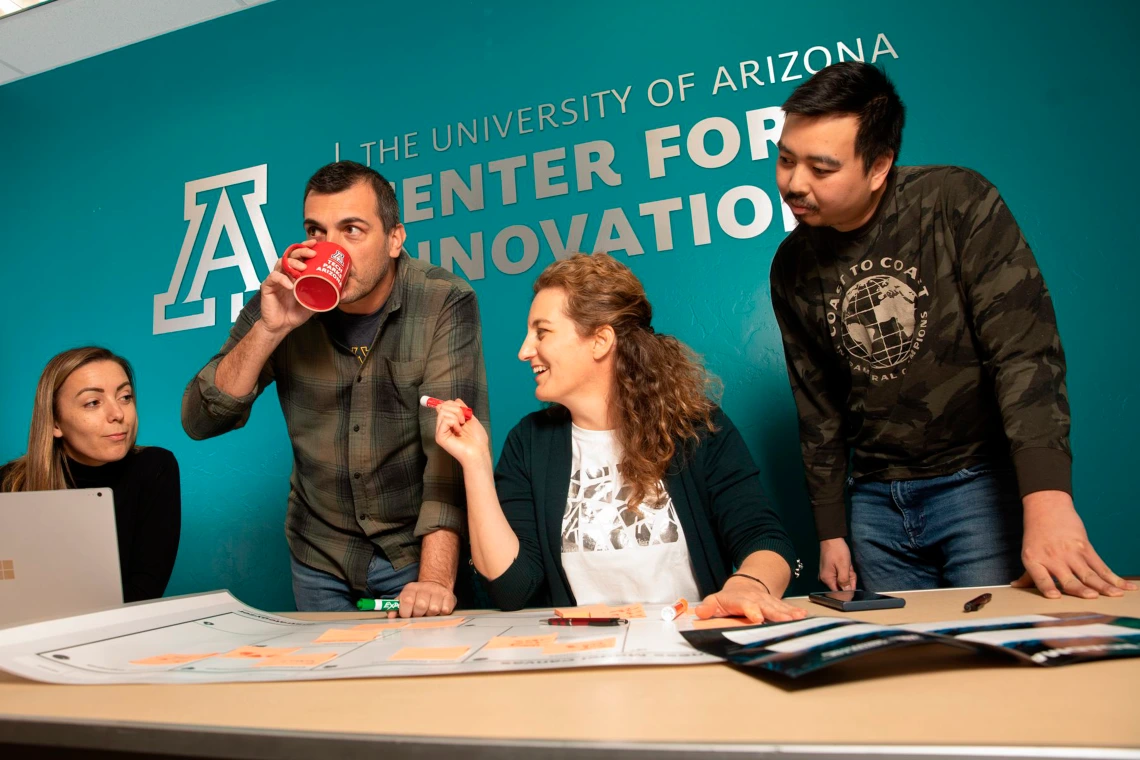 Center for Innovation employees chat at help desk