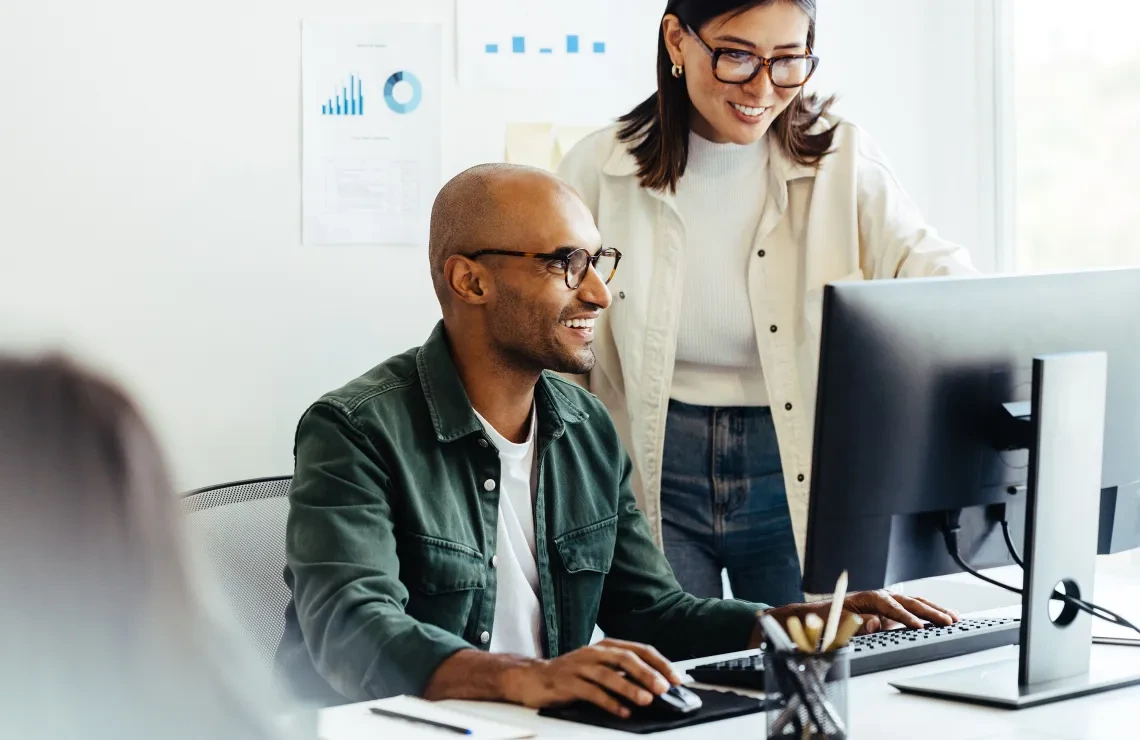 Stock image of people working around a computer