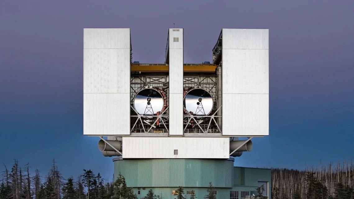 The Large Binocular Telescope stands tall above the treetops.