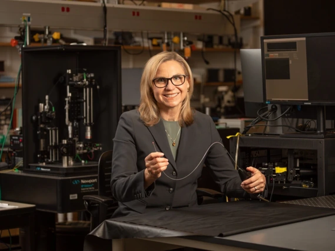 Jennifer Barton in a lab holding an ovarian cancer detection falloposcope