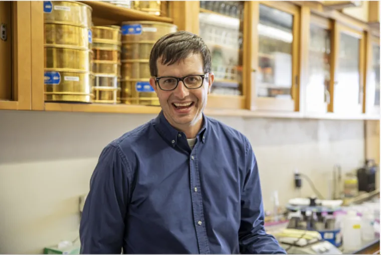 Joey Blankinship stands in his lab and smiles at the camera