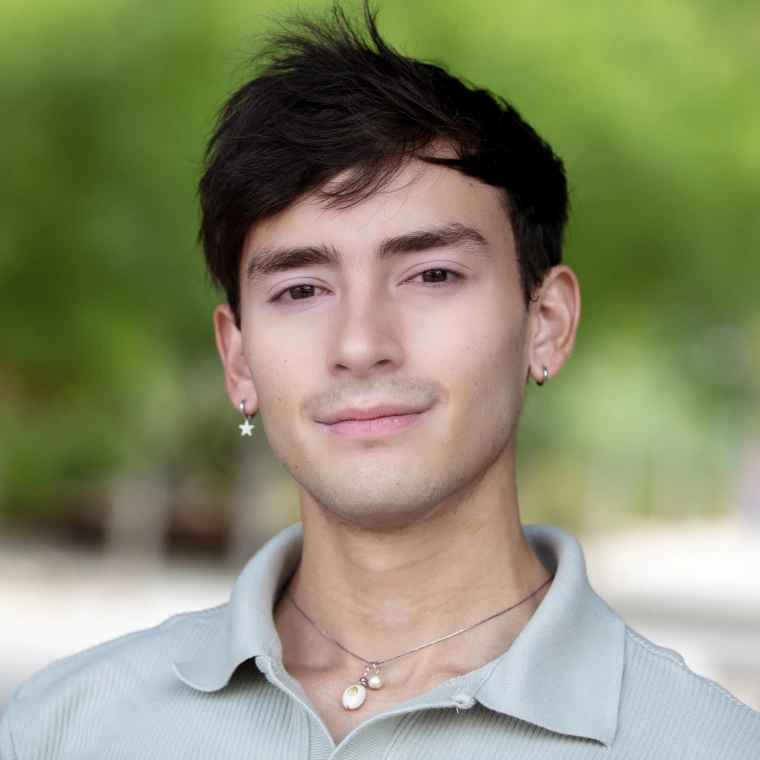 Dark haired young man with light blue shirt