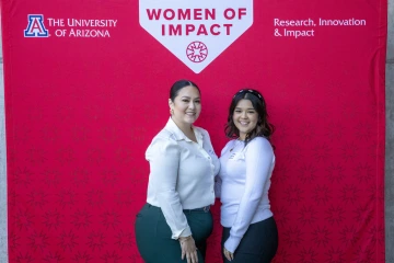 Image of YWOI honoree Ailanie Figueroa posing with her luncheon guest