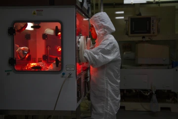 a women in protective garments in a lab