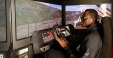 A U of A student uses Freeport-McMoRan’s haul truck simulator at a university event