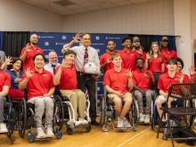 U of A President Suresh Garimella accepts a ceremonial basketball, autographed by members of the national champion men's wheelchair basketball team
