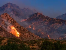 wildfires burning in a desert mountain range