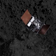 Artist's impression showing the OSIRIS-REx spacecraft descending onto Bennu's surface to collect a s