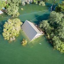 aerial view of a rooftop just above flood waters