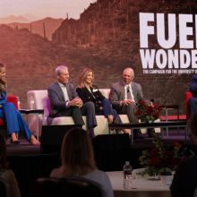 five people sitting on a stage in front of a backdrop that says &quot;fuel wonder&quot;