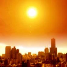 the sun casting an orange glow over a blurry city skyline