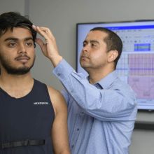 a researcher working with a sensor on a study participant