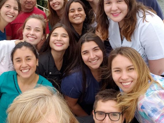 PROFILE: Specialist Jane Carrington and Kimberly Shea picture with group of students smiling