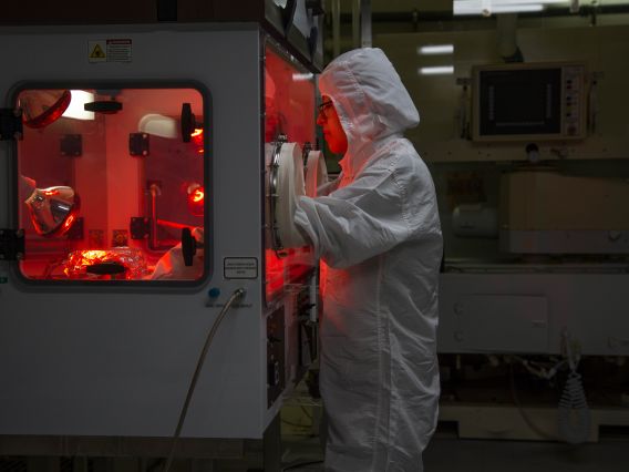 a women in protective garments in a lab