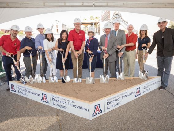 people holding shovels at a groundbreaking
