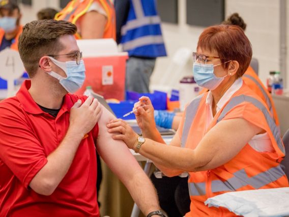 a man getting the COVID-19 vaccine