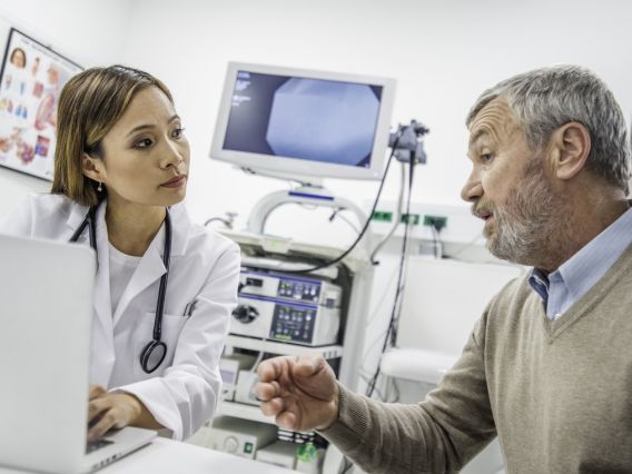 A medical professional listens to a patient.
