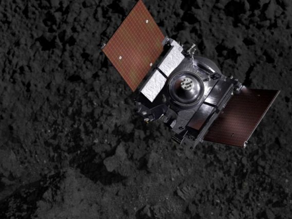 Artist's impression showing the OSIRIS-REx spacecraft descending onto Bennu's surface to collect a s