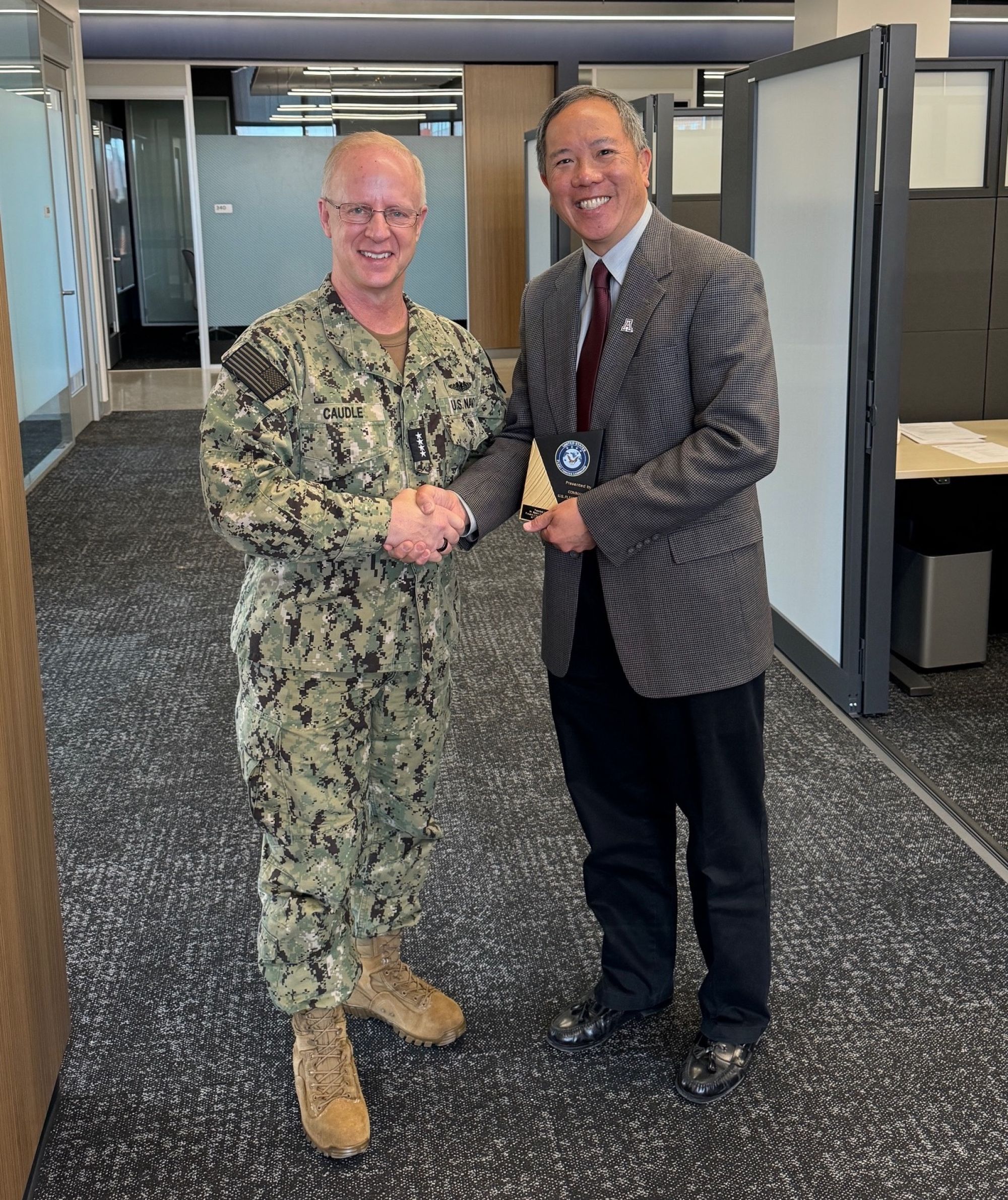 Admiral Caudle presents Elliott Cheu with a plaque