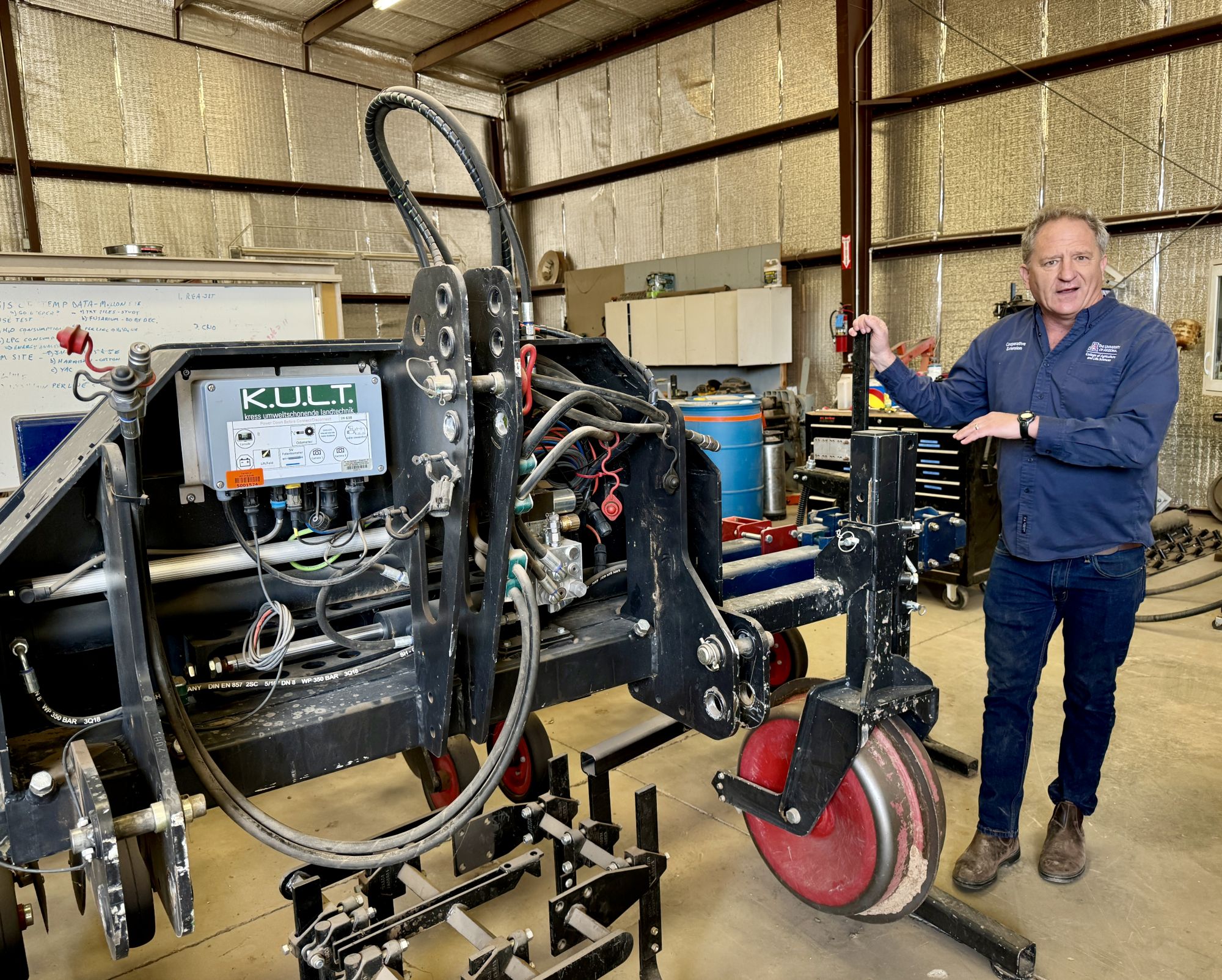 Mark Siemens, associate professor of biosystems engineering, stands beside technology he incorporates into his focus of precision and mechanized agriculture.