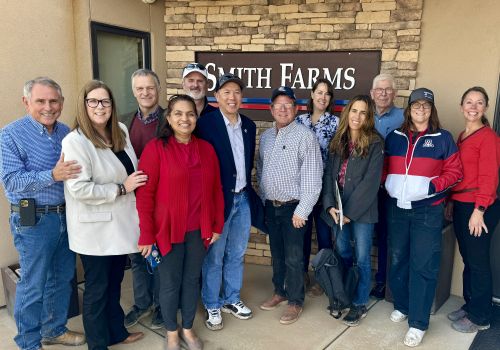 The RII leadership team is joined by other individuals for a photo outside of Smith Farms in Yuma.