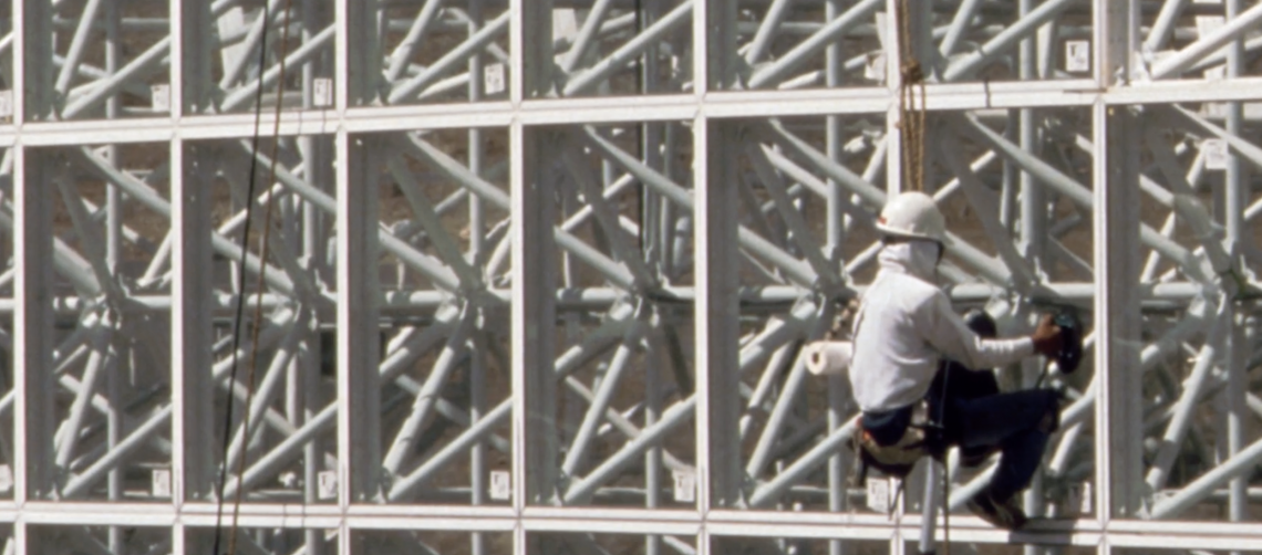 worker climbing wall of biosphere 2 structure