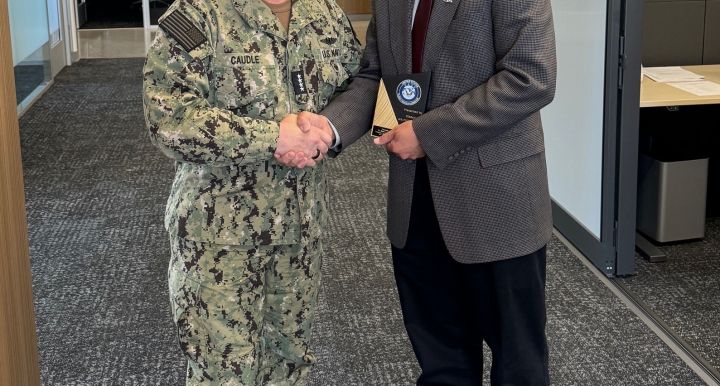 Admiral Caudle presents Elliott Cheu with a plaque
