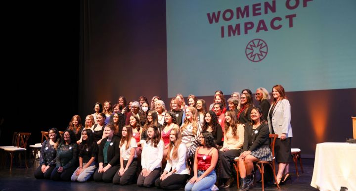 The 2023 Women of Impact and Young Women of Impact cohorts pose for a picture after the awards celeb